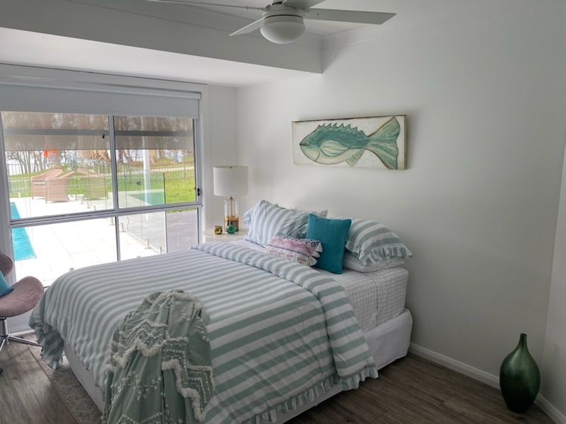 A Bedroom with a Bed and a Ceiling Fan — JWP Painting & Property Services in Sydney, NSW