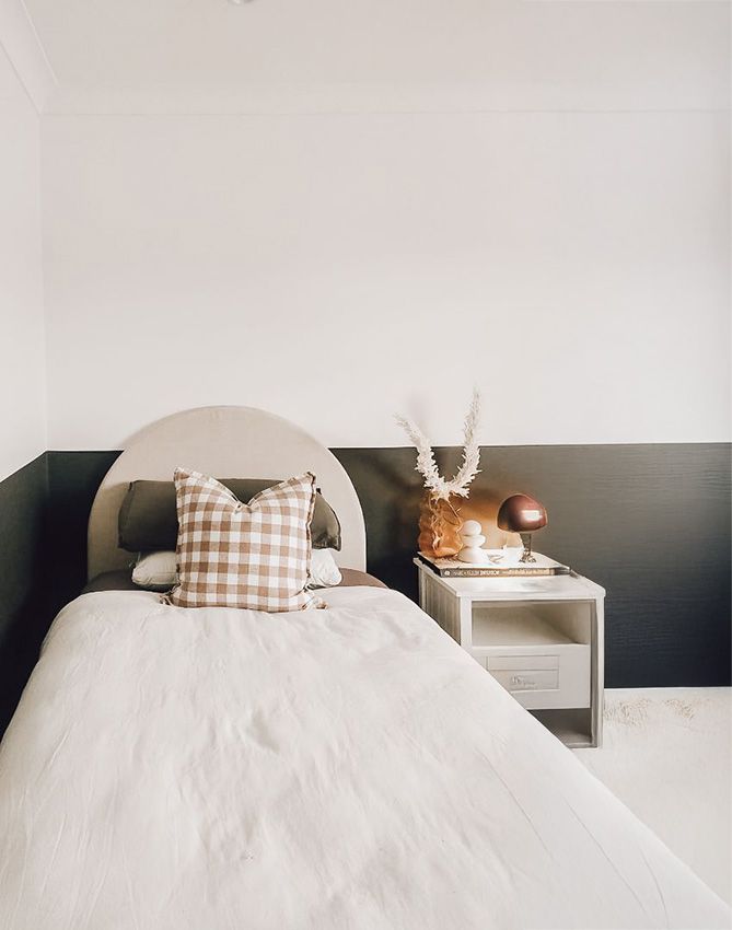 A Bedroom with a Bed, Nightstand, and Lamp — JWP Painting & Property Services in Ettalong Beach, NSW