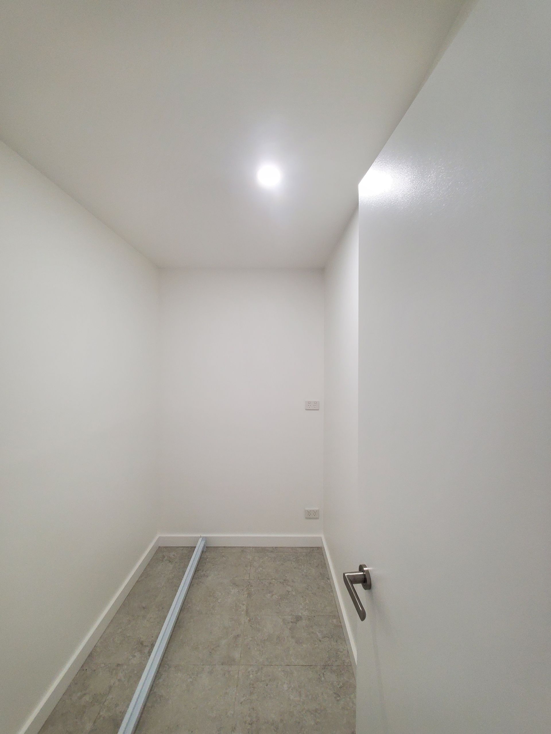 Empty, White-walled Room With a Grey Floor — JWP Painting & Property Services in Ettalong Beach, NSW