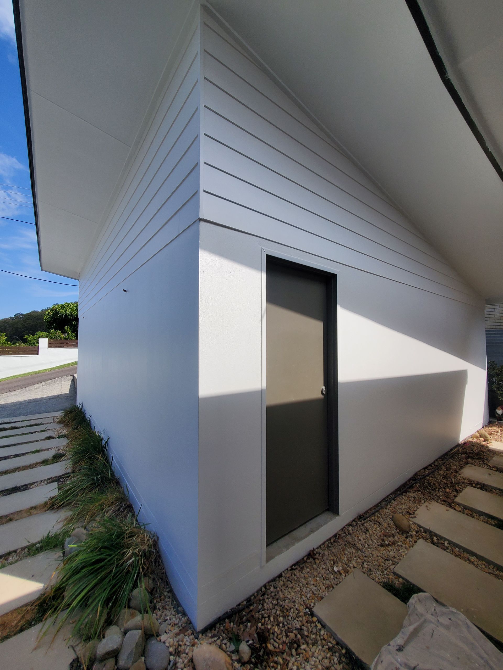 Exterior of a White Building With a Dark Door — JWP Painting & Property Services in Ettalong Beach, NSW