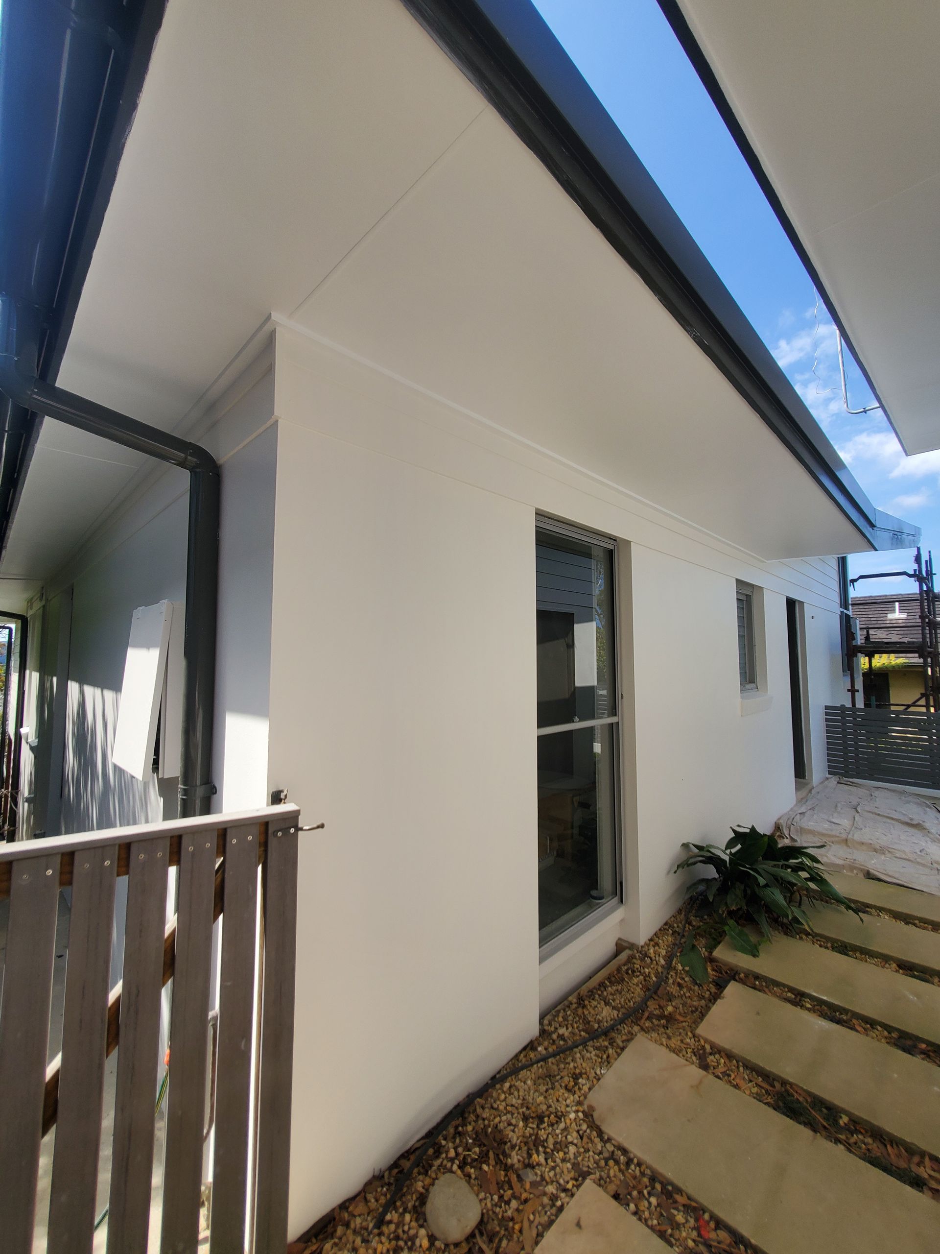 House Exterior With Grey Trim, a Window, and a Stone Pathway — JWP Painting & Property Services in Ettalong Beach, NSW