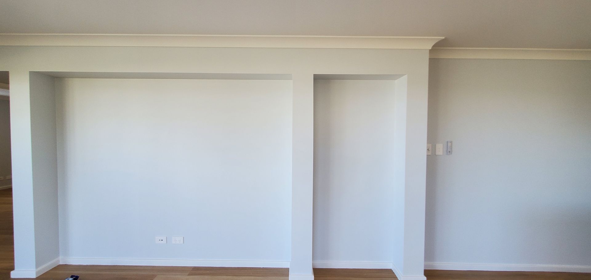 A Living Room With White Walls and a Wooden Floor — JWP Painting & Property Services in Ettalong Beach, NSW
