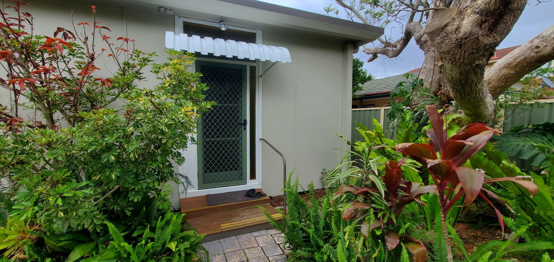 A Small White House With a White Awning Over the Door — JWP Painting & Property Services in Ettalong Beach, NSW