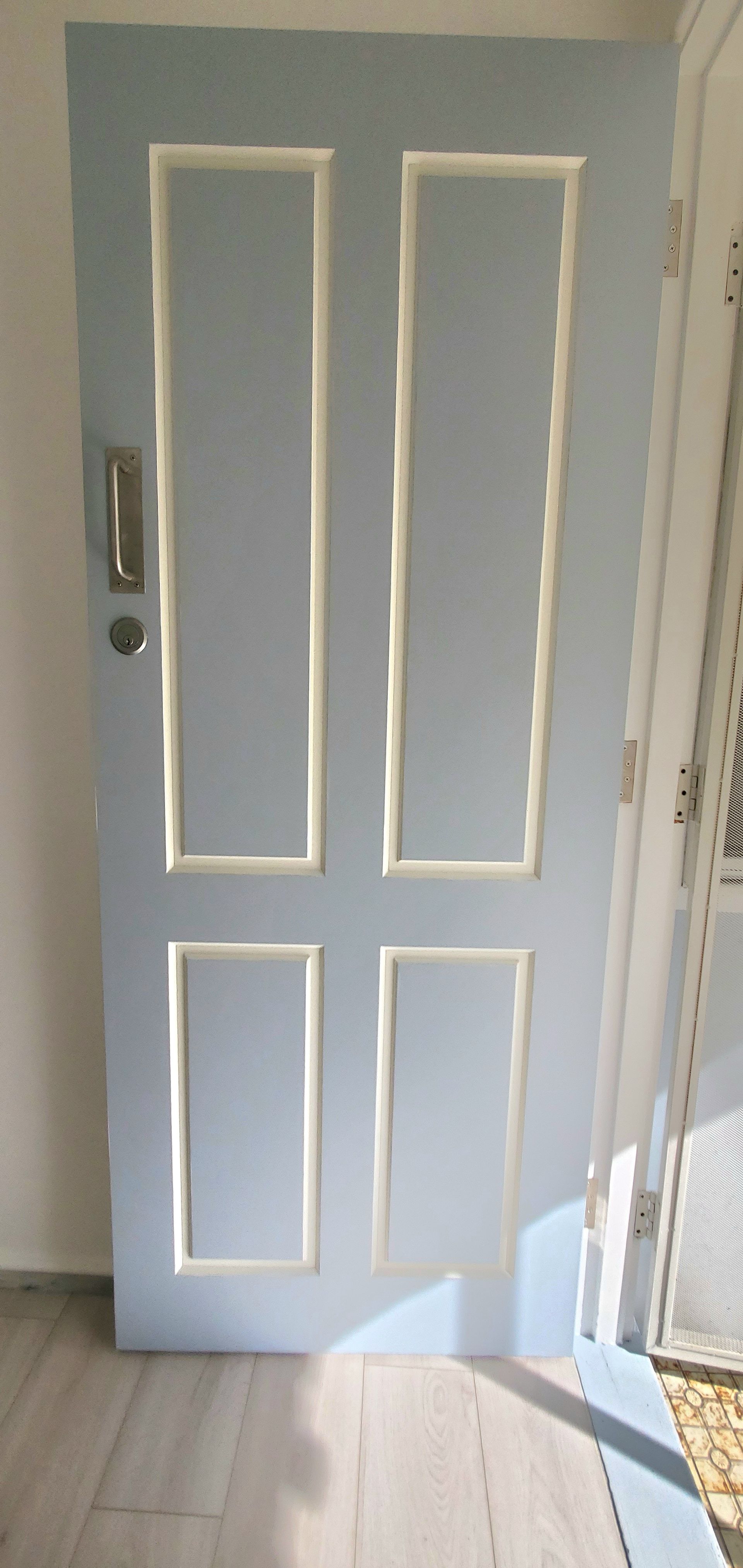 A Light Blue Door With White Trim is in a Room — JWP Painting & Property Services in Ettalong Beach, NSW