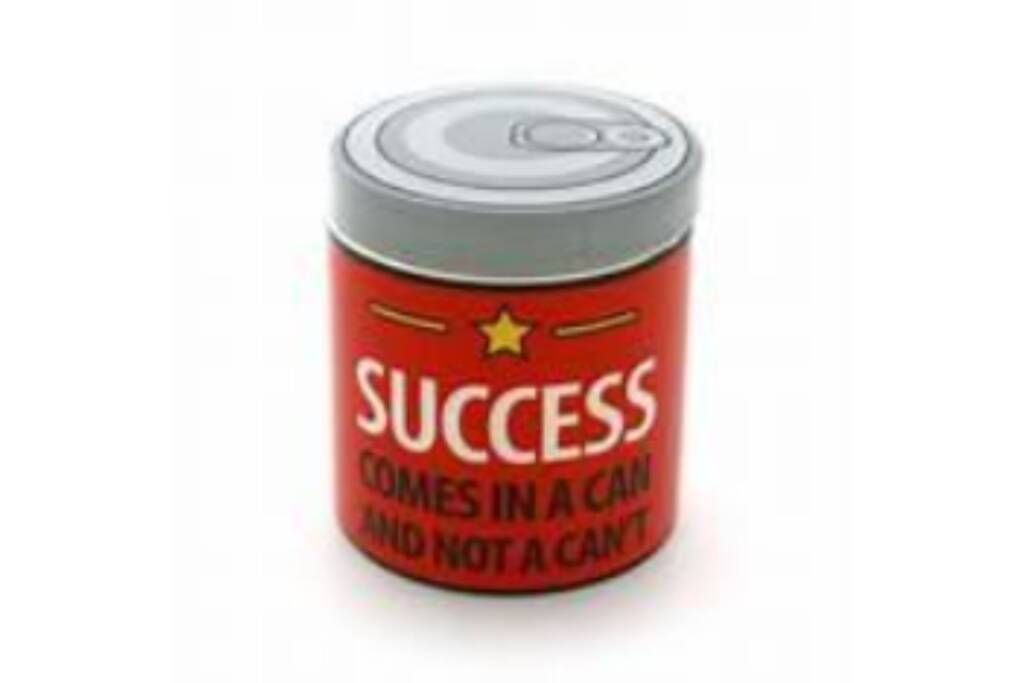 Silver can with red label reading “SUCCESS comes in a can and not a can”