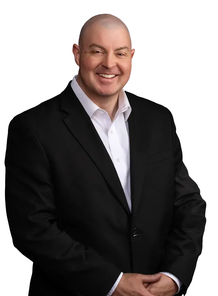 Andy Brough portrait looking at the viewer. He has a suit and is against a transparent background.