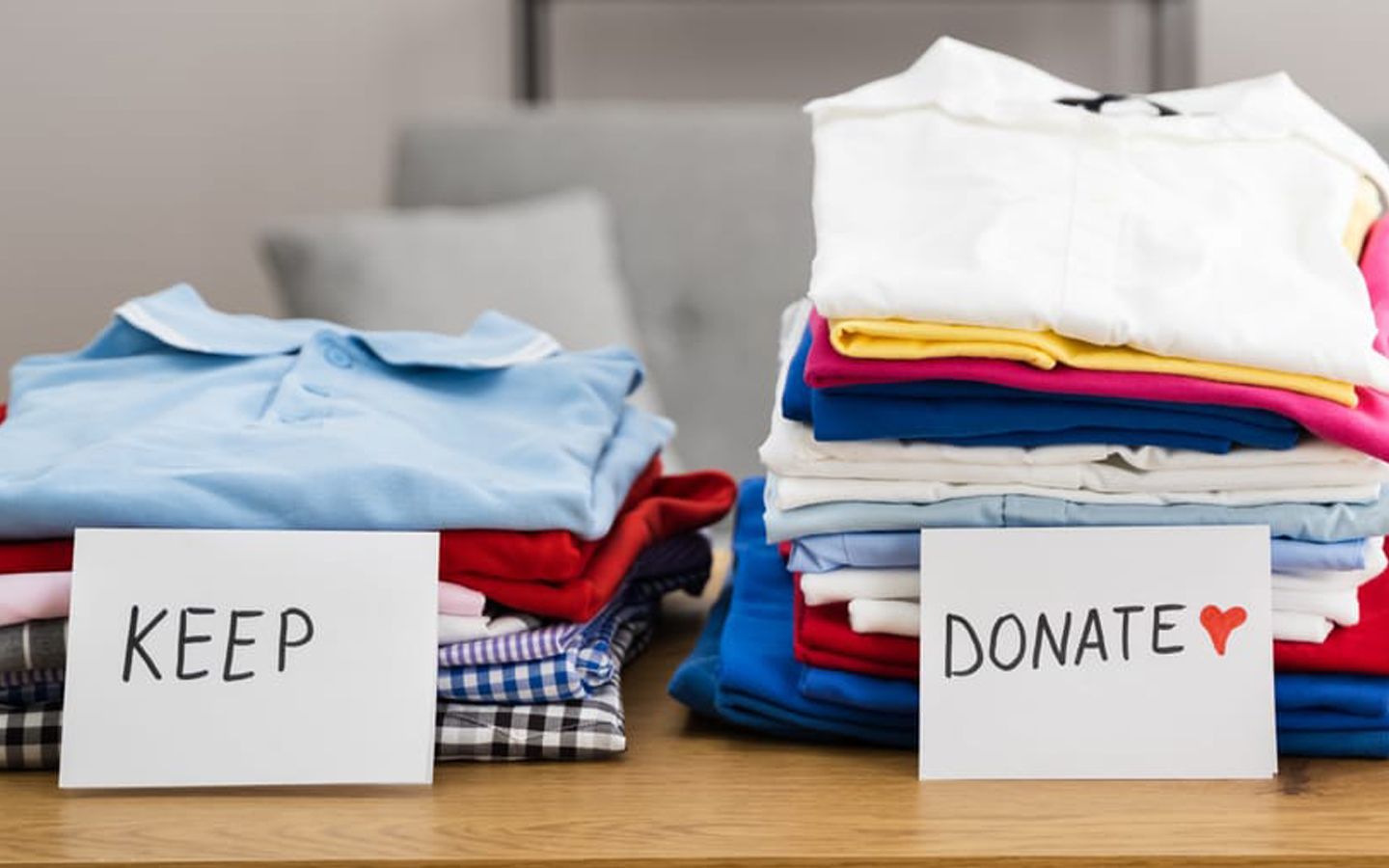 Piles of folded clothes labeled