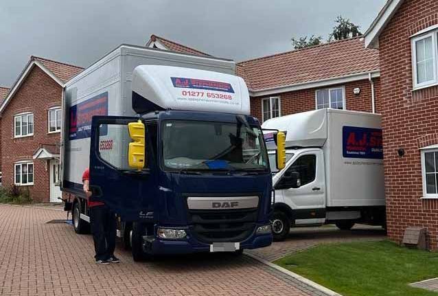 aj stephenson removals vans outside a house ready to be moved