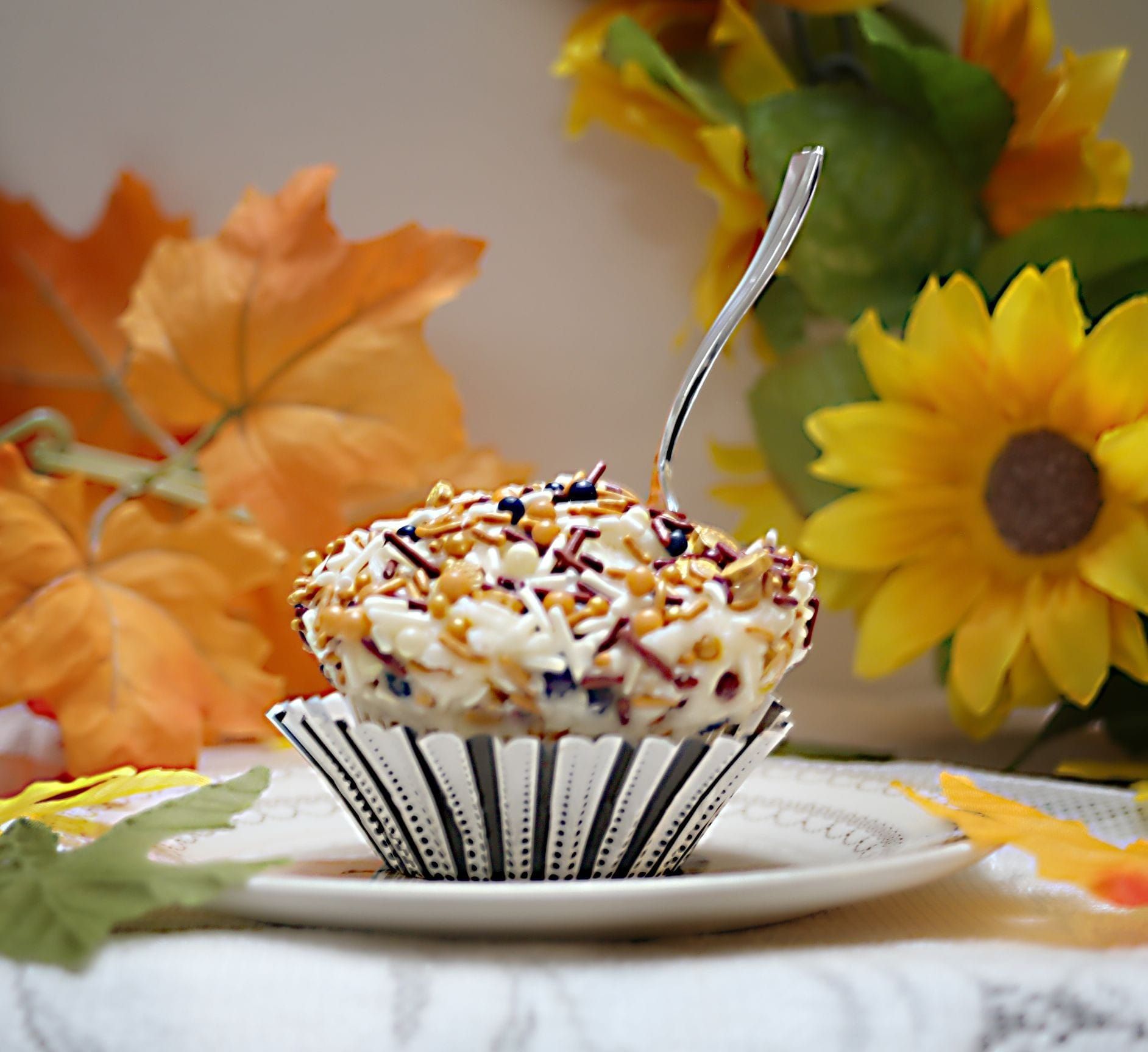 a cupcake on a plate with a fork in it