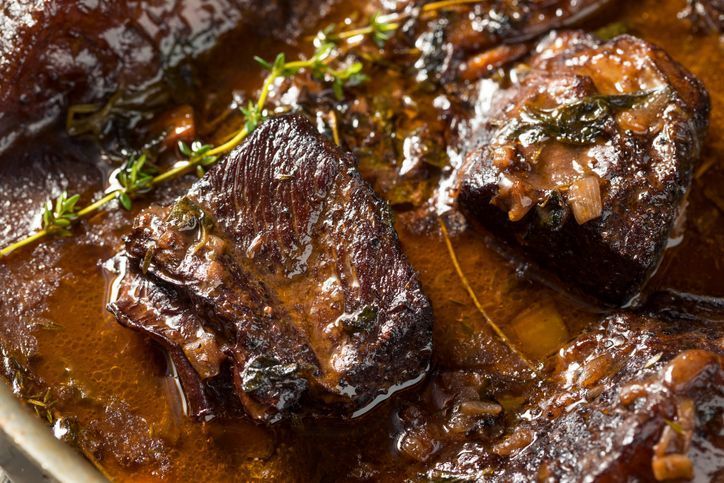 a close up of a piece of meat in a sauce