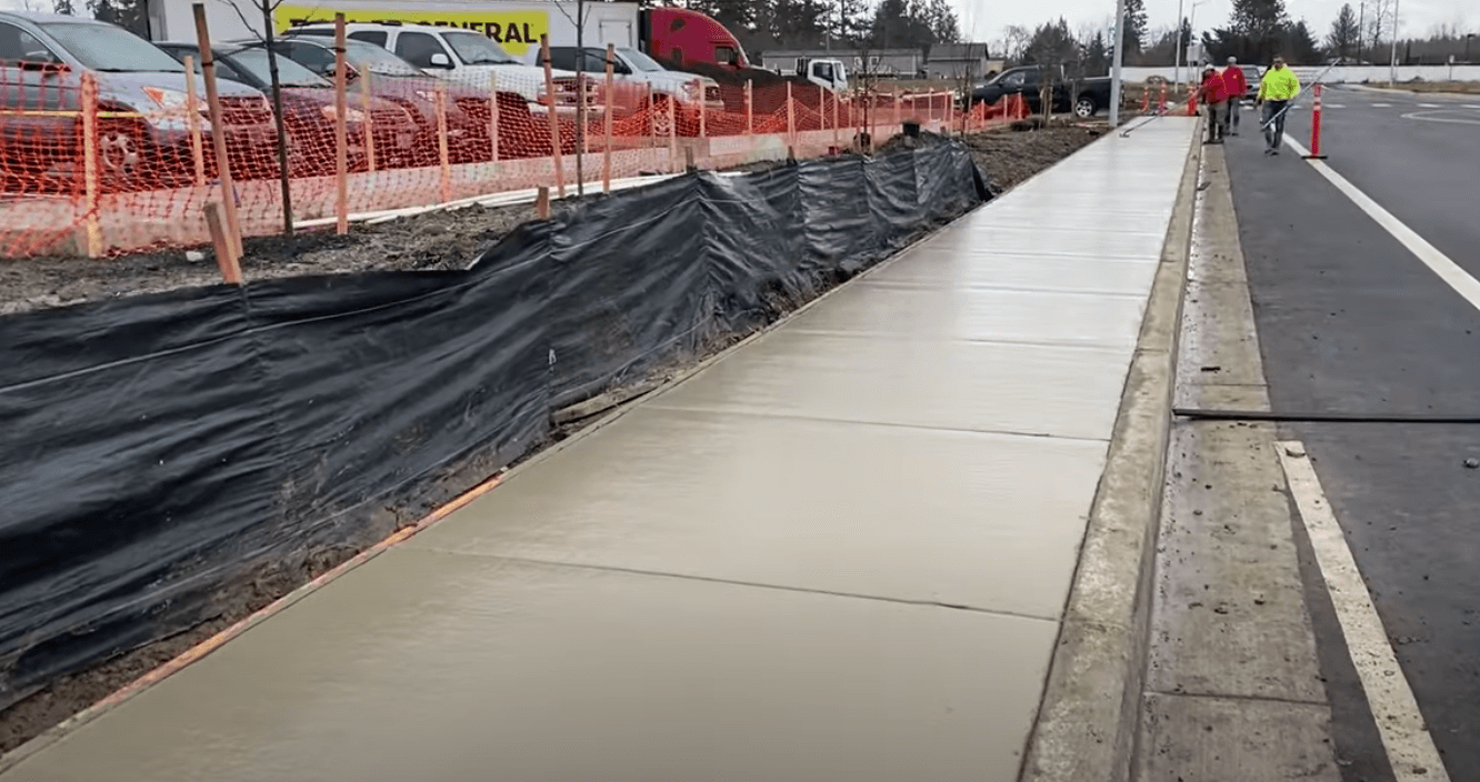 Concrete contractor pouring out a new sidewalk for a residential house in sacramento, CA