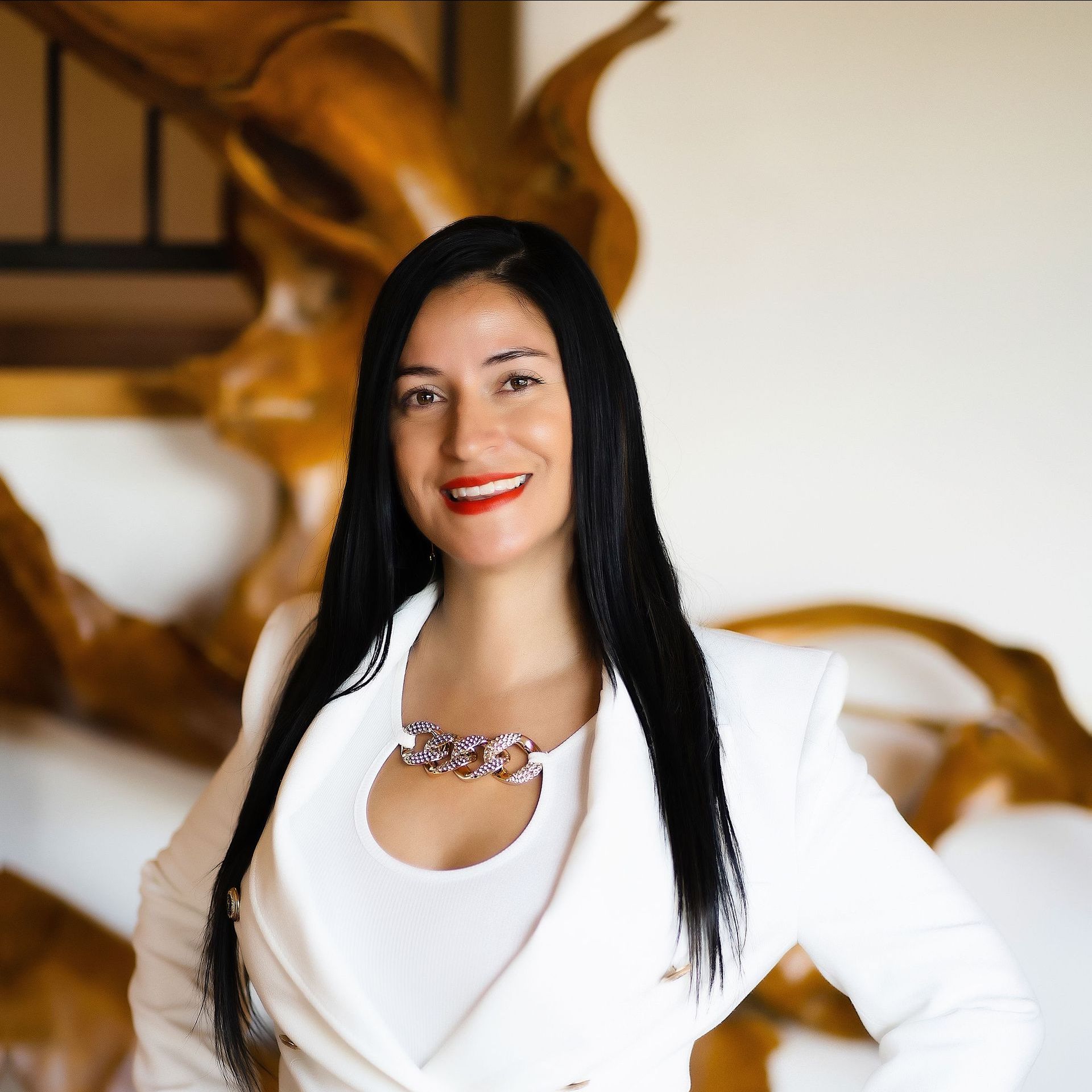 A woman with long black hair is wearing a white jacket