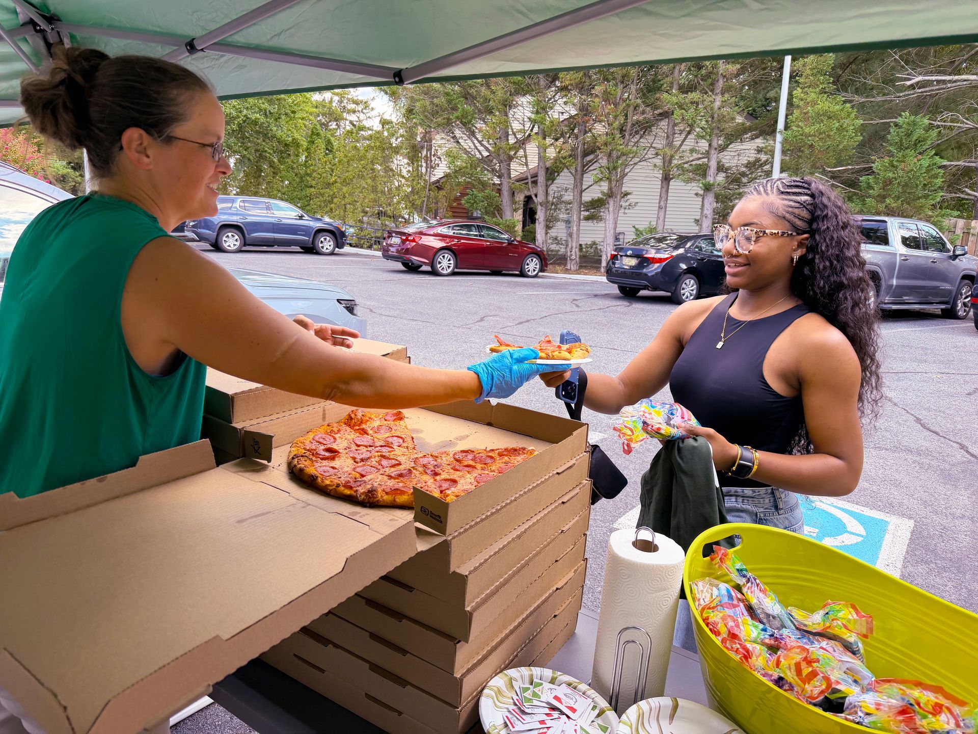 DSP receiving a slice of pepperoni pizza from Mayabellas!