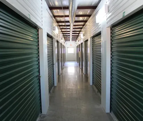 hallway of climate controlled storage units with green doors