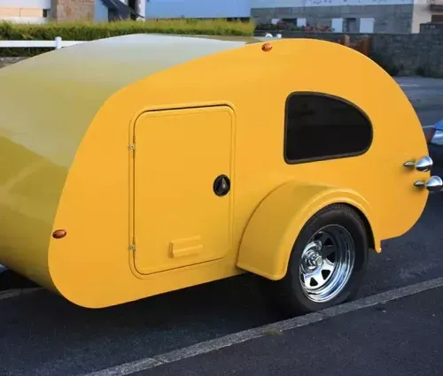 yellow trailer rv parked in parking lot