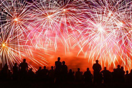 Fireworks in the sky with shadows watching