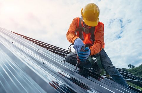 Worker Installing New Roof — Apollo Beach, FL — Tampa Bay Contracting Co, LLC Worker Installing New Roof — Apollo Beach, FL — Tampa Bay Contracting Co, LLC