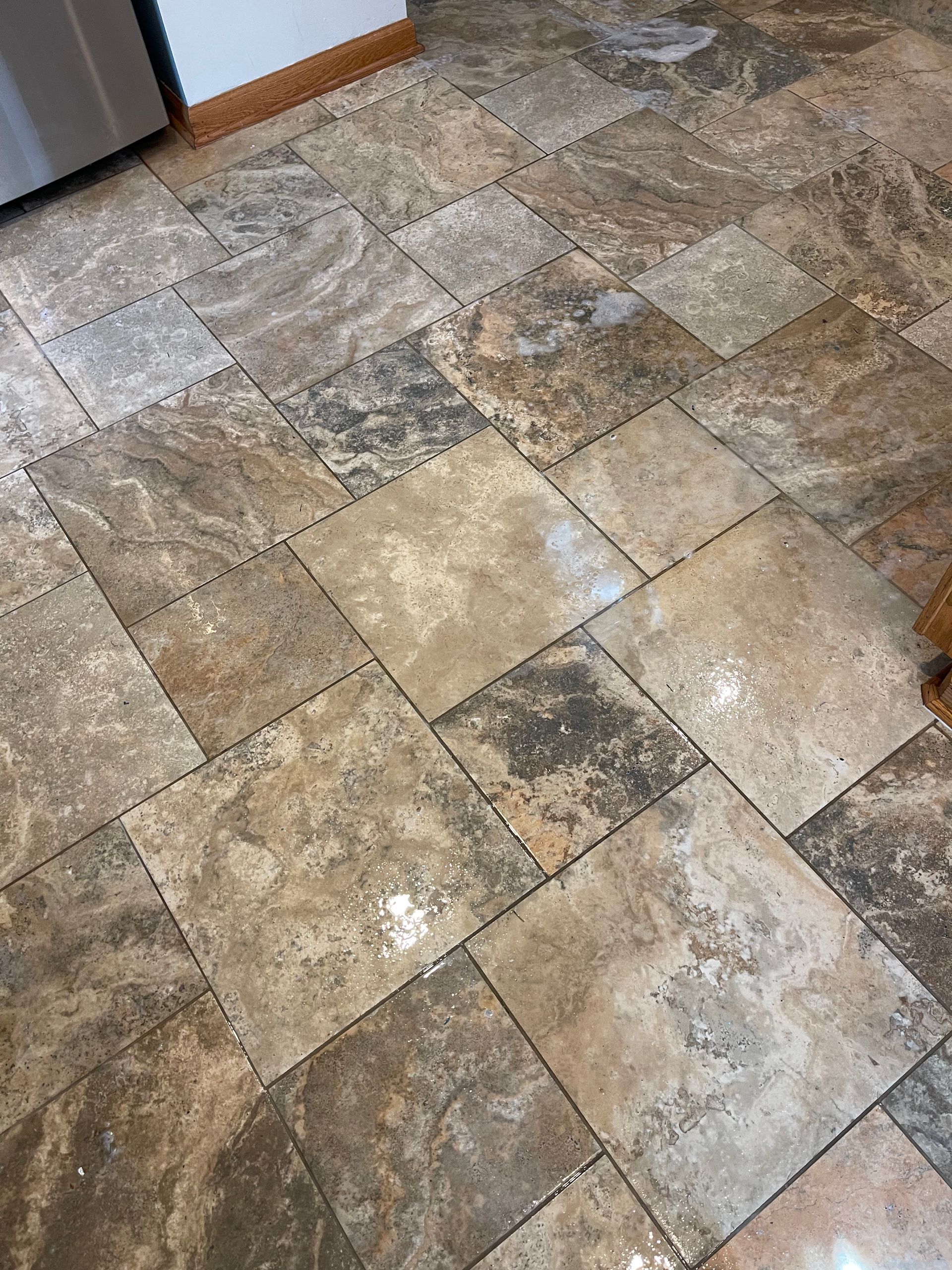A close up of a tiled floor in a kitchen.