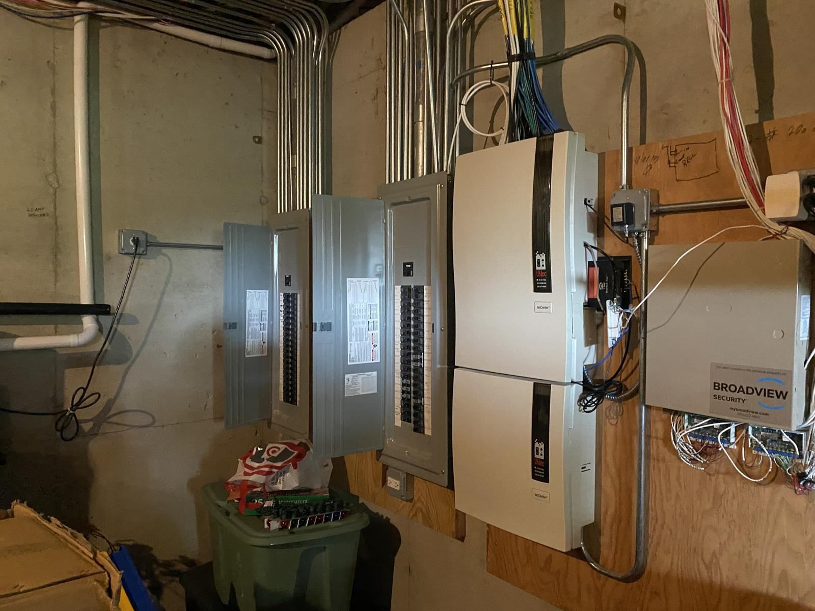 A room with a lot of electrical equipment on the wall.