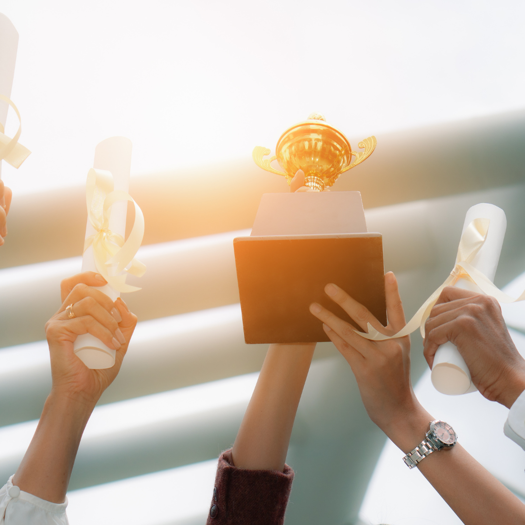 Hands Raised in the Air, Holding a Gold Trophy — Michelle Crutcher Business Coaching & Consulting in The Entrance North, NSW