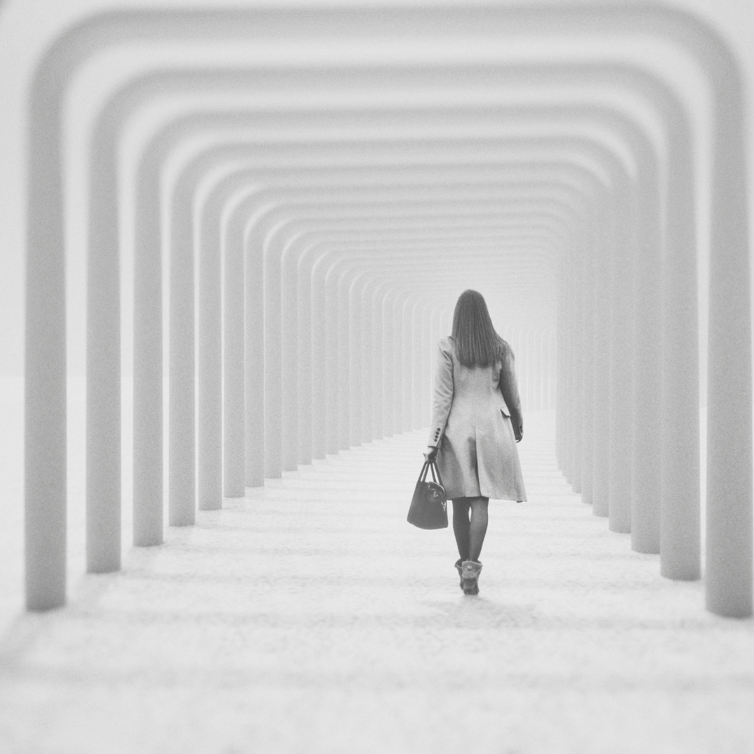 A Person in a Coat Walks Away Into a Long — Michelle Crutcher Business Coaching & Consulting in The Entrance North, NSW