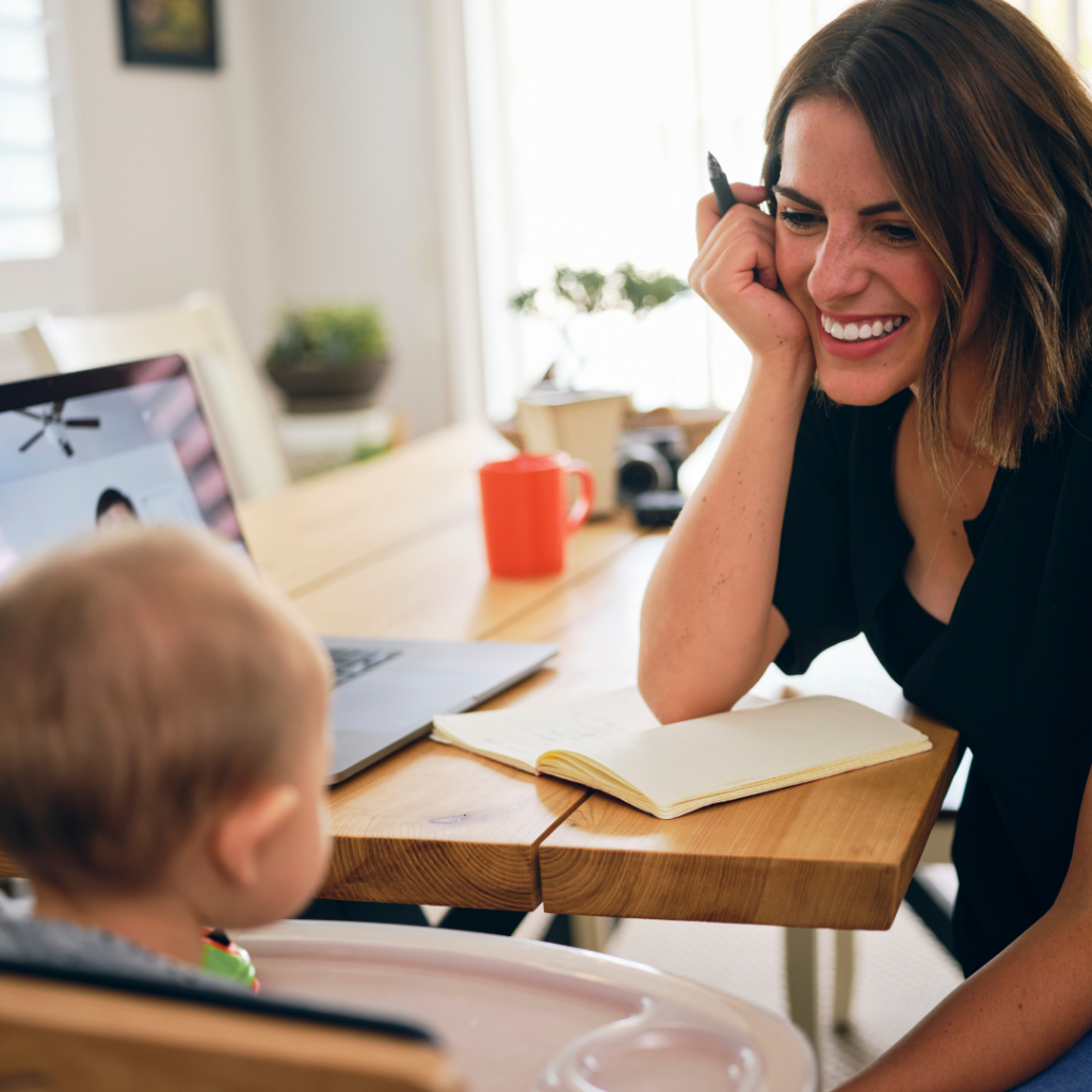 A Person Smiles at a Baby in a High Chair — Michelle Crutcher Business Coaching & Consulting in The Entrance North, NSW
