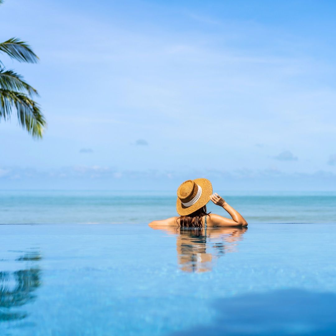 A Woman in a Straw Hat Relaxes by the Pool — Michelle Crutcher Business Coaching & Consulting in The Entrance North, NSW