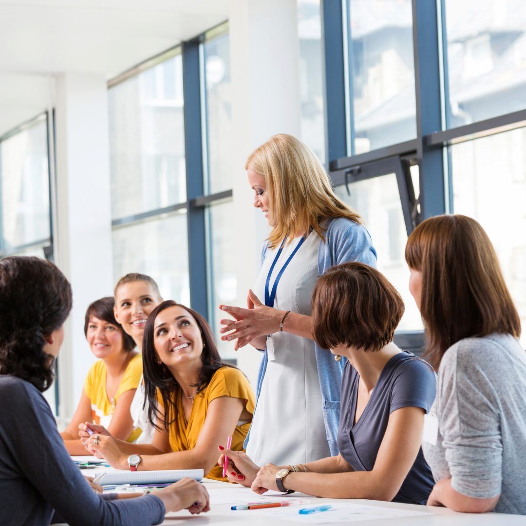 A Woman Stands And Speaks To Five Seated Women โ Michelle Crutcher Business Coaching & Consulting in The Entrance North, NSW