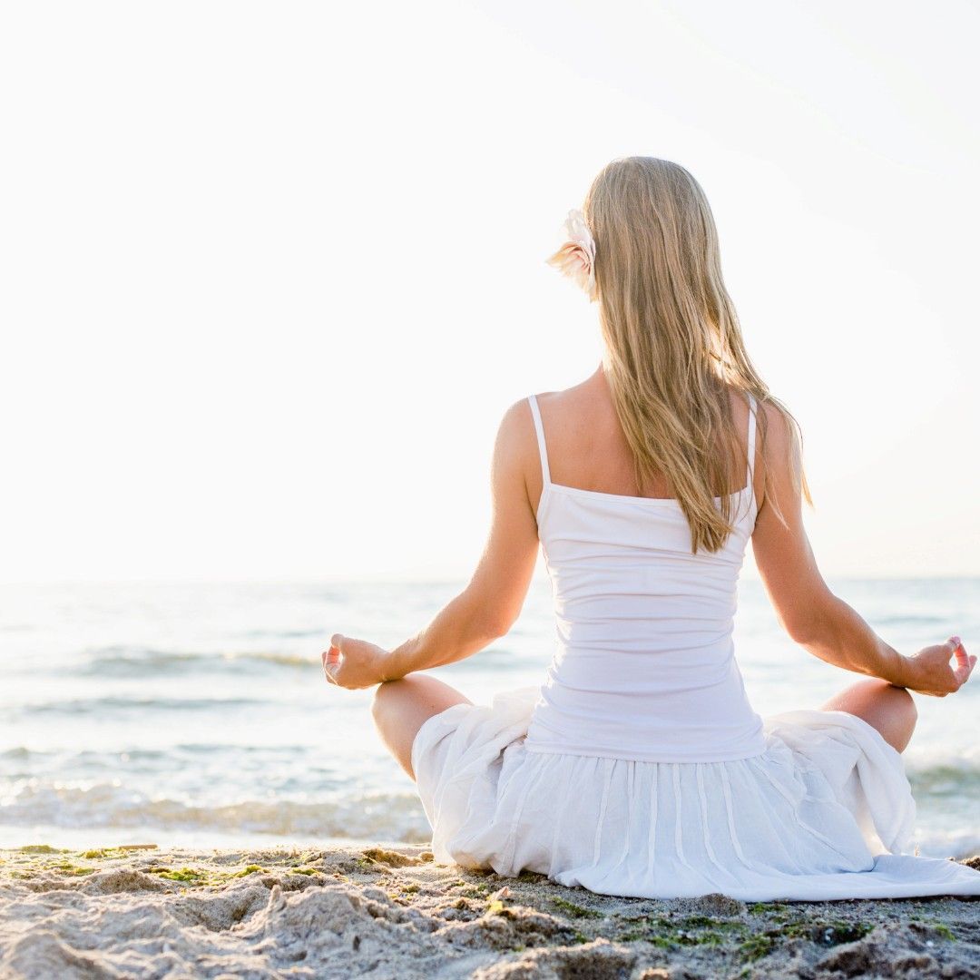 Woman Meditating On A Sandy Beach — Michelle Crutcher Business Coaching & Consulting in The Entrance North, NSW