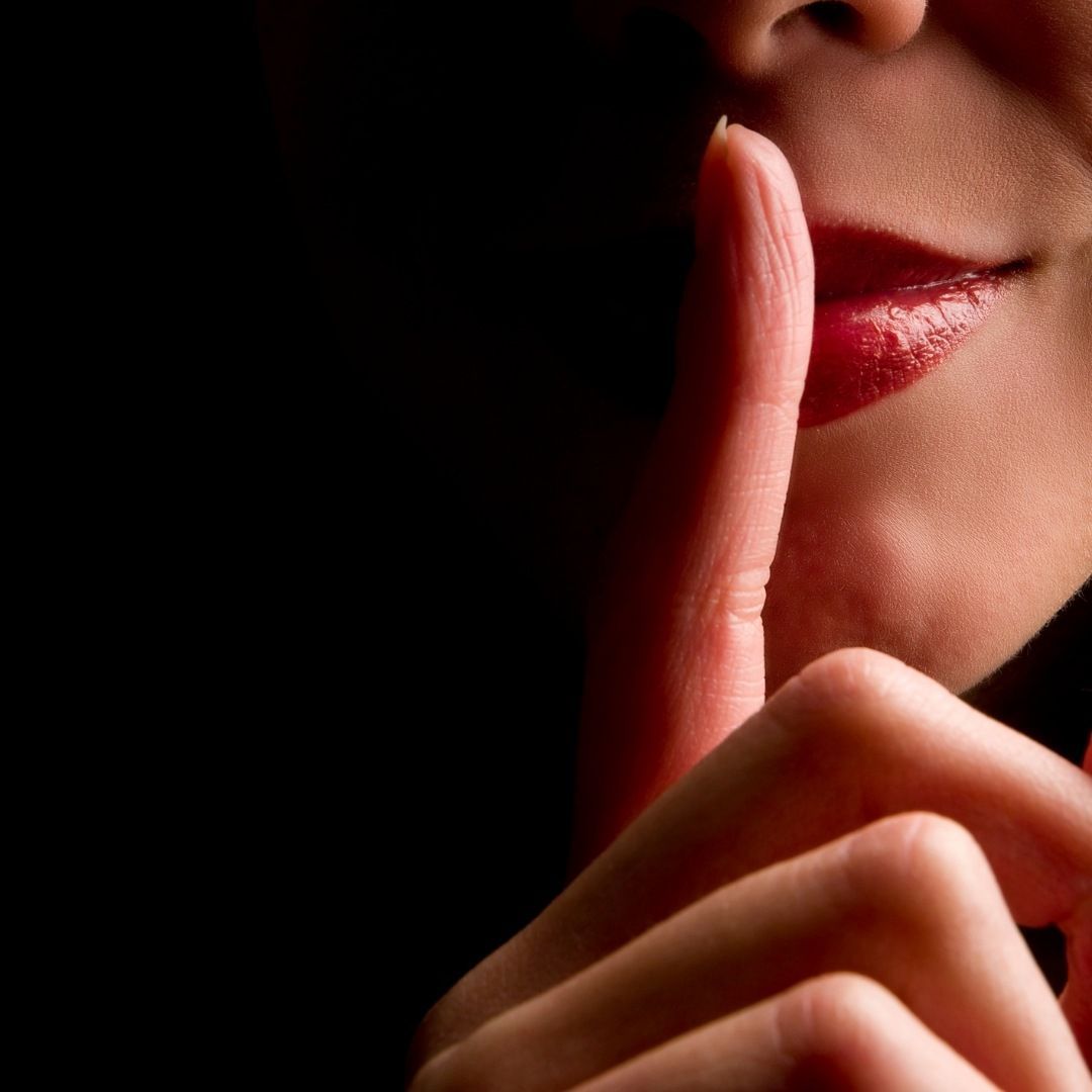 A Person Holding A Finger To Their Lips — Michelle Crutcher Business Coaching & Consulting in The Entrance North, NSW