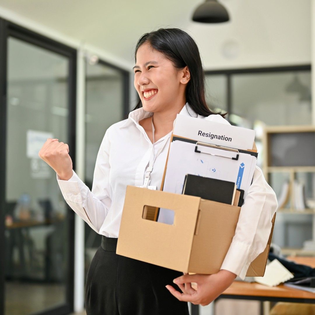 Smiling Woman in Office Holding a Box — Michelle Crutcher Business Coaching & Consulting in The Entrance North, NSW