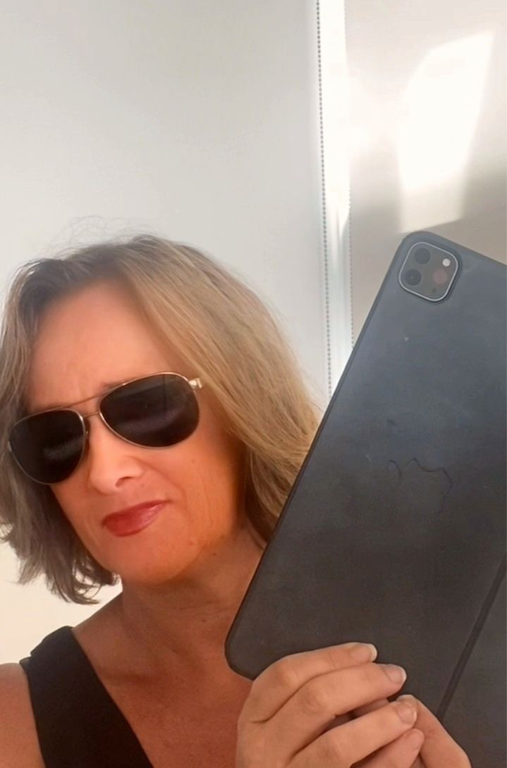 A Woman Wears Sunglasses And Holds A Tablet โ Michelle Crutcher Business Coaching & Consulting in The Entrance North, NSW