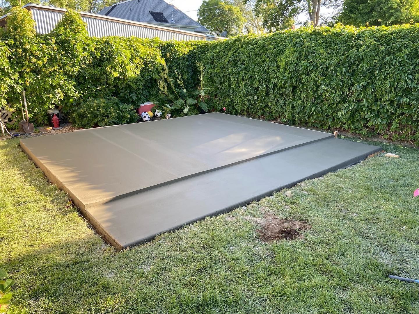 A large concrete slab is sitting on top of a lush green lawn.
