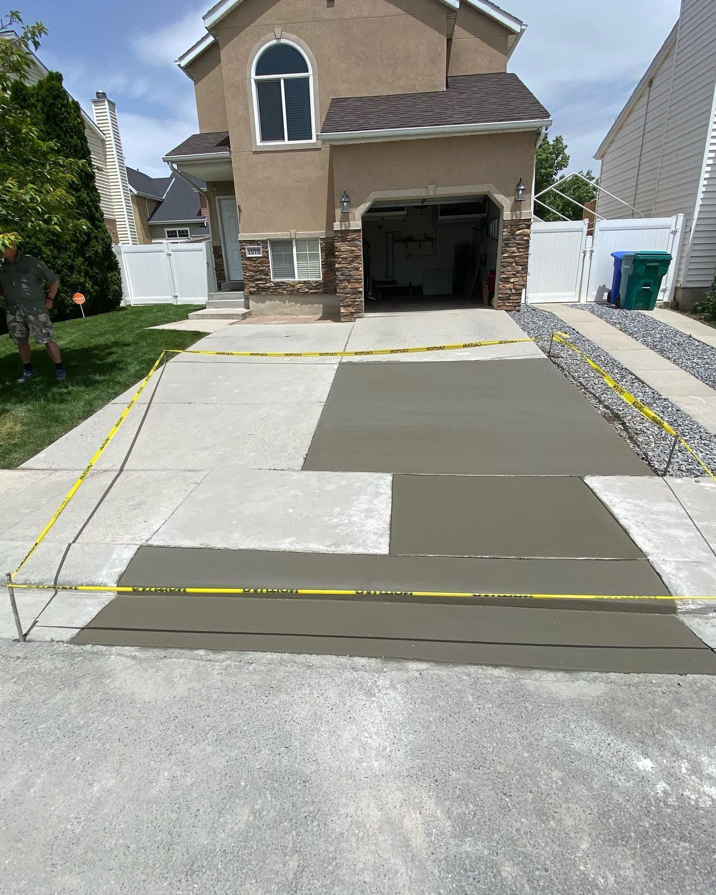 A concrete driveway is being built in front of a house.