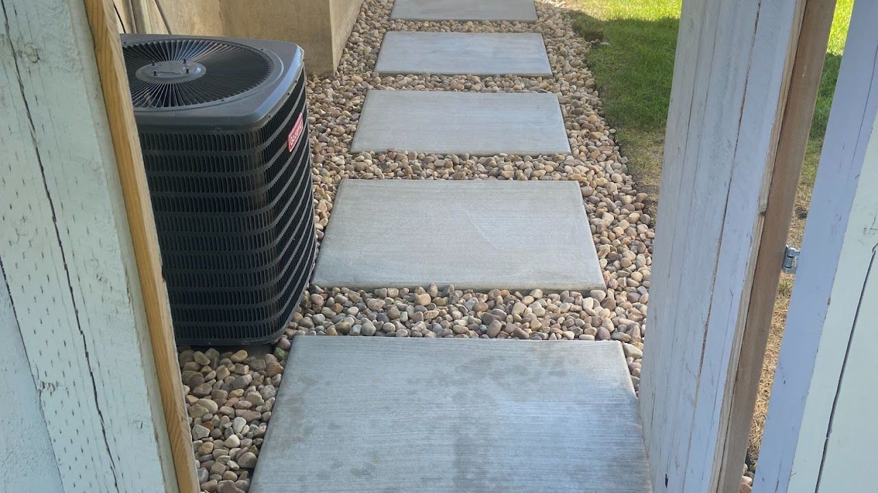 A walkway with a black air conditioner on the side of it.