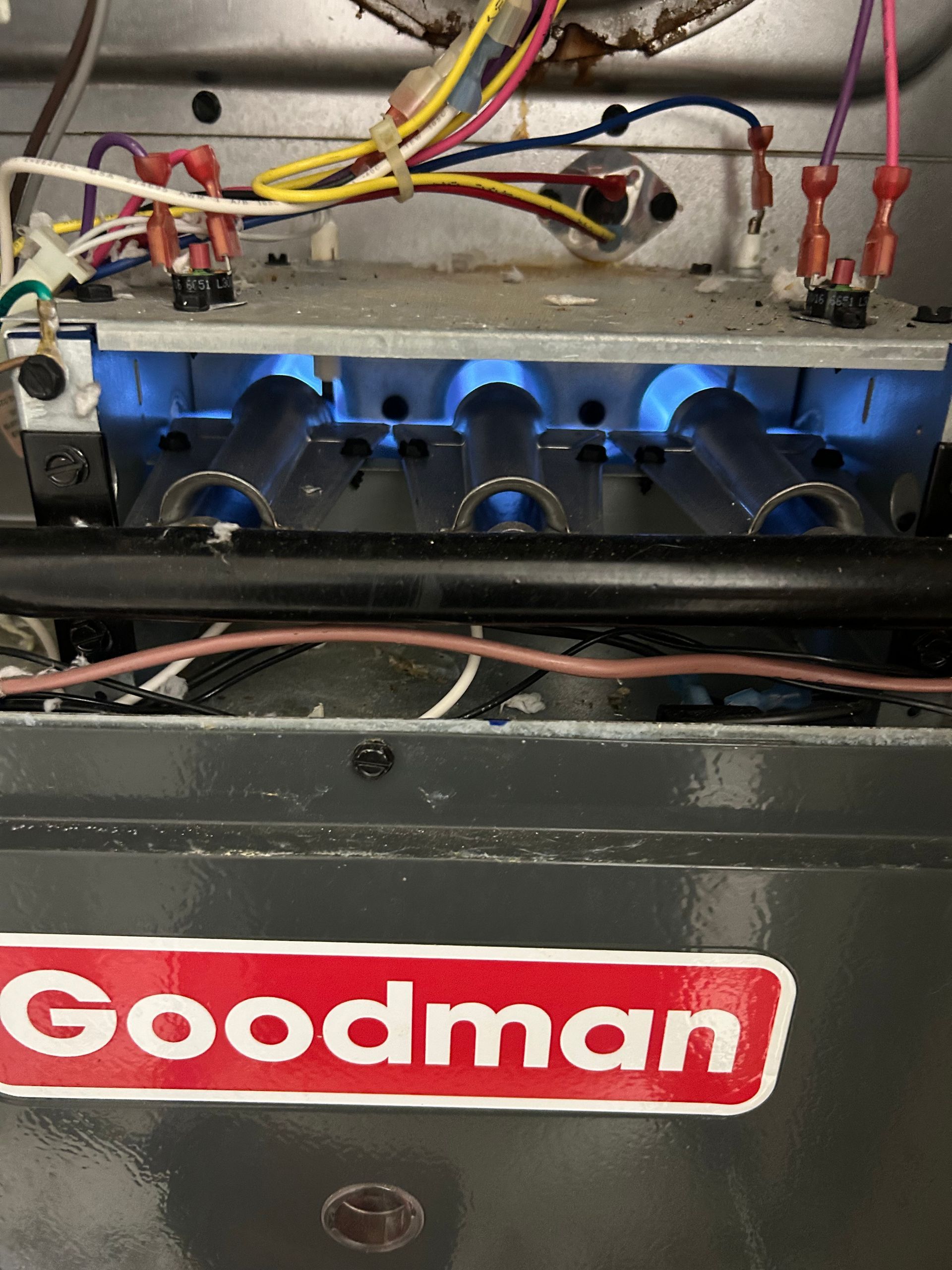 repairing a goodman gas furnace and checking the burners for proper combustion 
