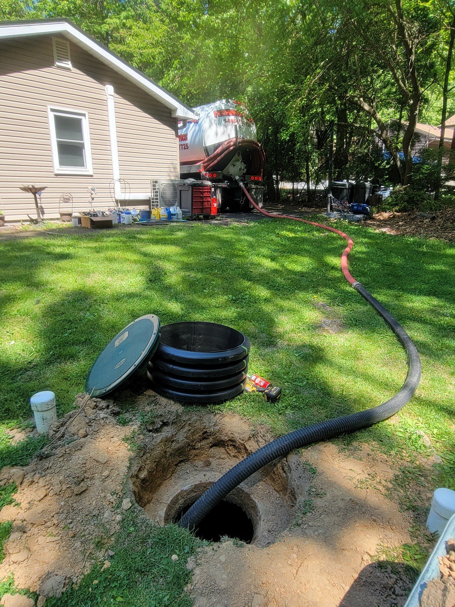 Pumping Septic Tank In The Backyard — Bethel, PA — Peterman Bros. Septic Service