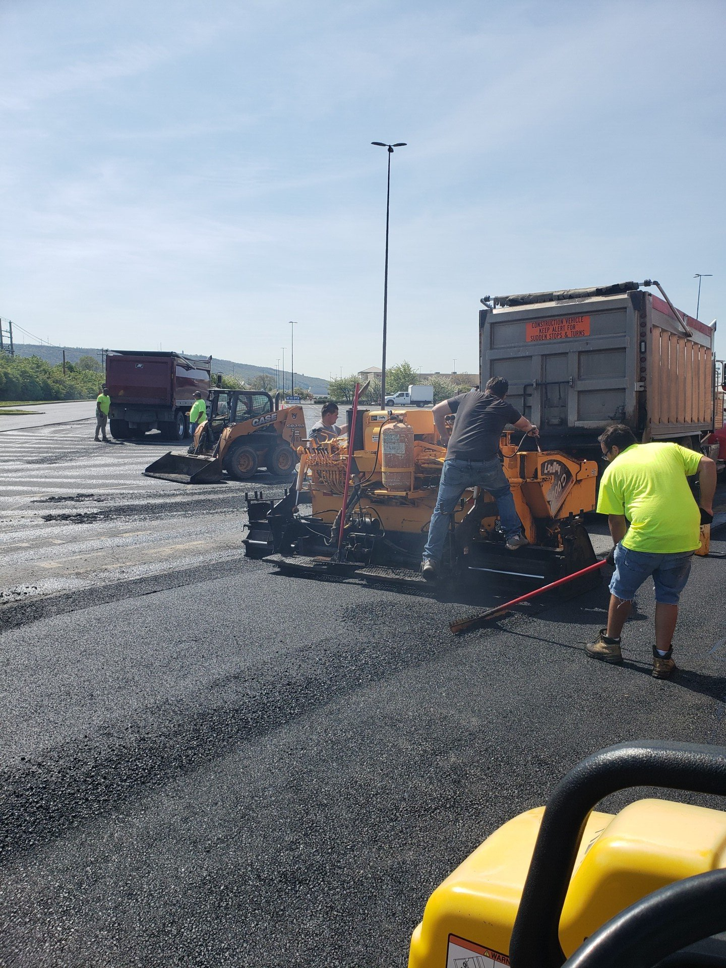 Workers Adding Asphalt And Sealcoating — Bethel, PA — Peterman Bros. Septic Service