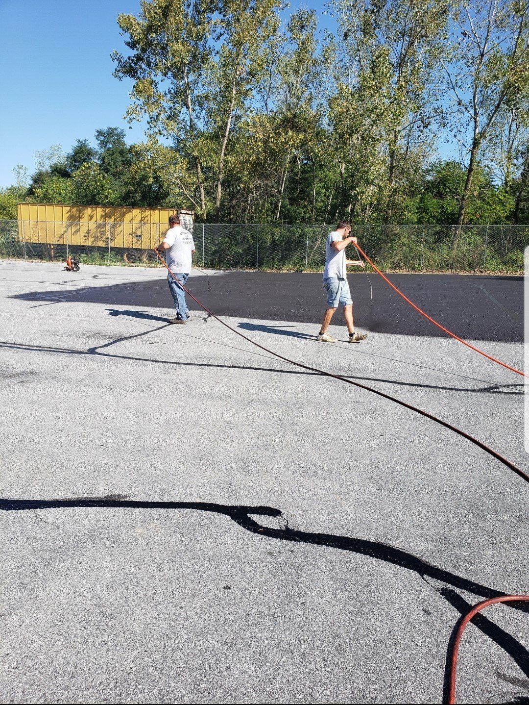 Two Workers Sealcoating Asphalt — Bethel, PA — Peterman Bros. Septic Service