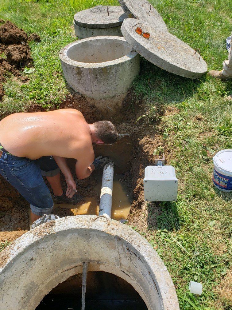 Man Checking Tube — Bethel, PA — Peterman Bros. Septic Service