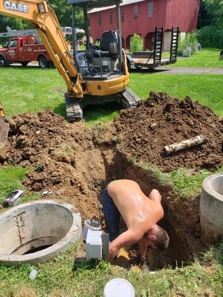 Man Checking Septic Tank Tube — Bethel, PA — Peterman Bros. Septic Service