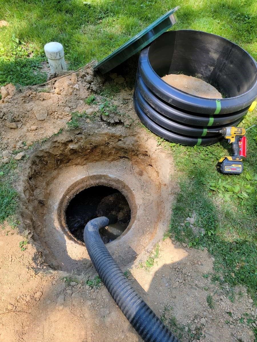 Pumping Septic Tank Using Black Hose — Bethel, PA — Peterman Bros. Septic Service