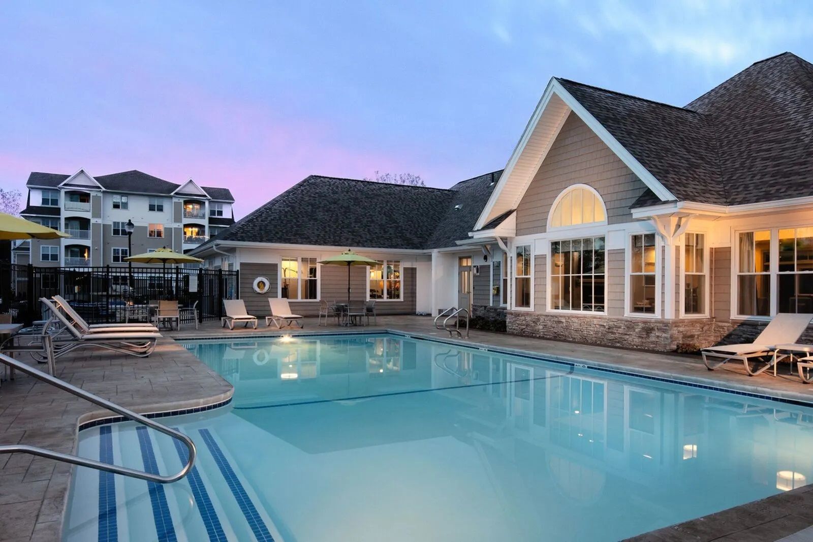 The Residences at Great Pond resort-style outdoor pool with beautiful sunset view 
