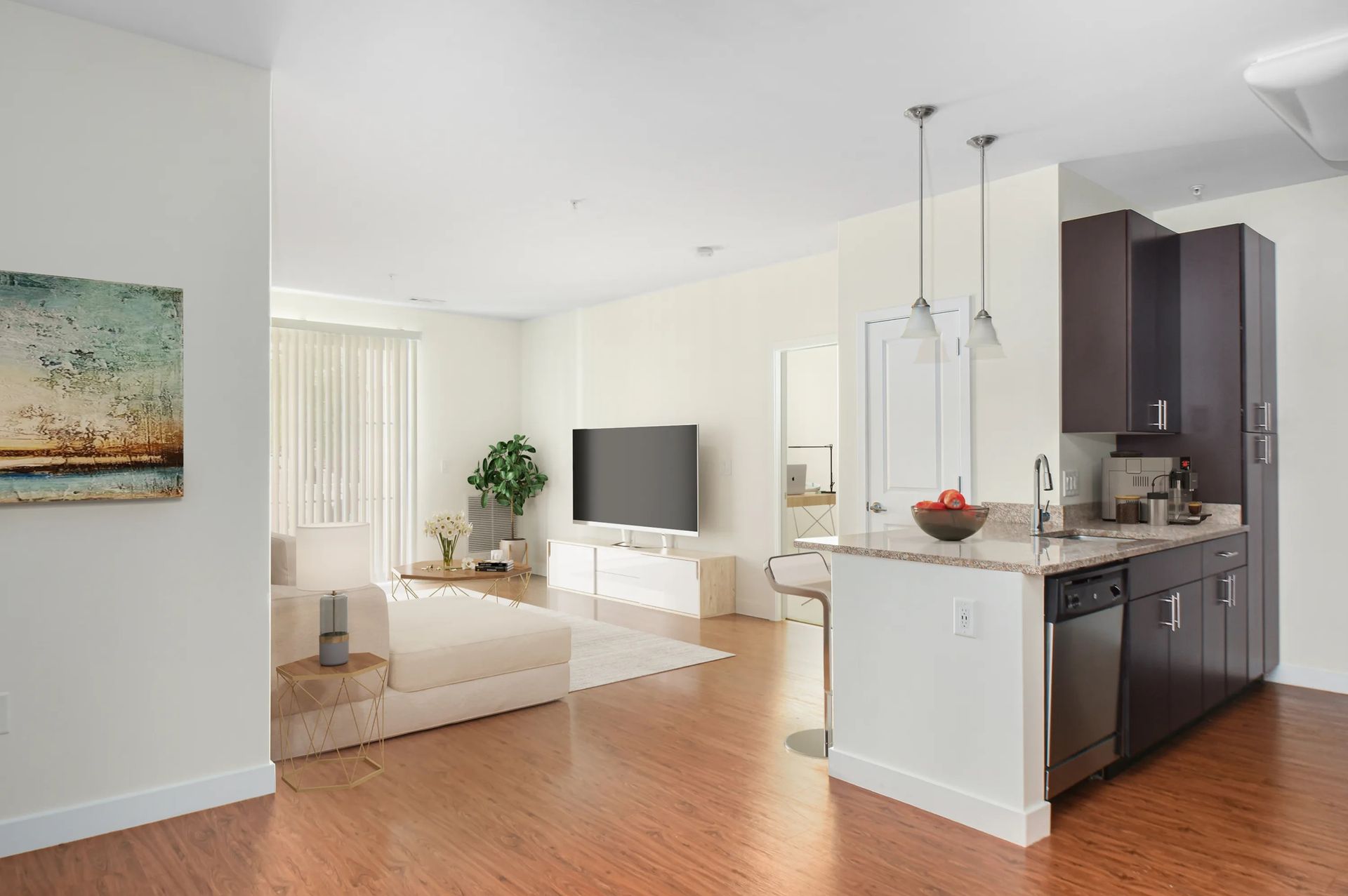 The Residences at Great Pond spacious floor plan with kitchen oversees the living room.