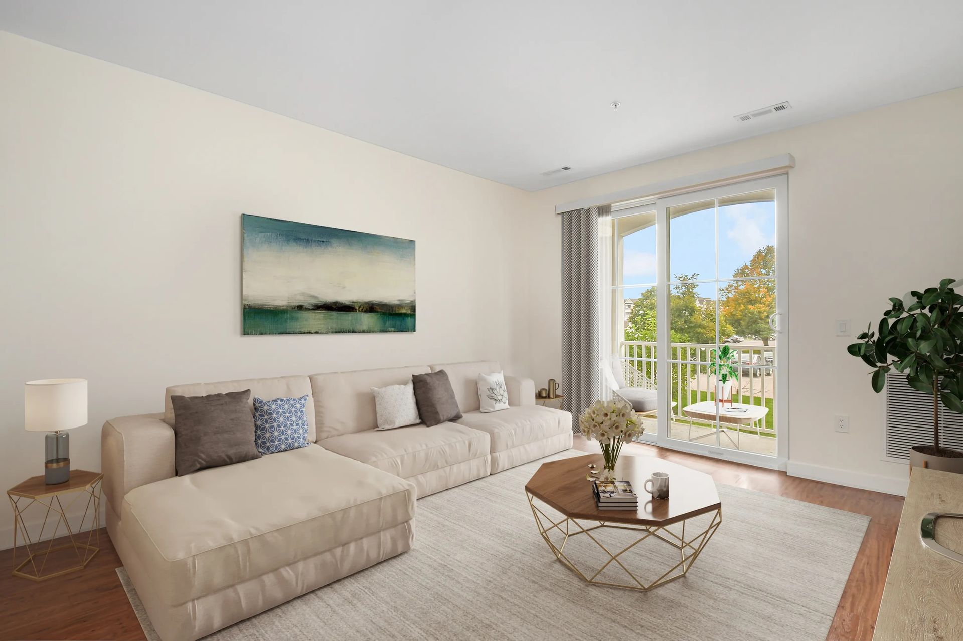 The Residences at Great Pond modern living room with cream color themed sofa, rug, coffee table, wall art, and an exit to balcony,