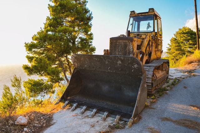 A bulldozer is parked on the side of a road.