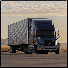 A volvo semi truck is parked on the side of the road