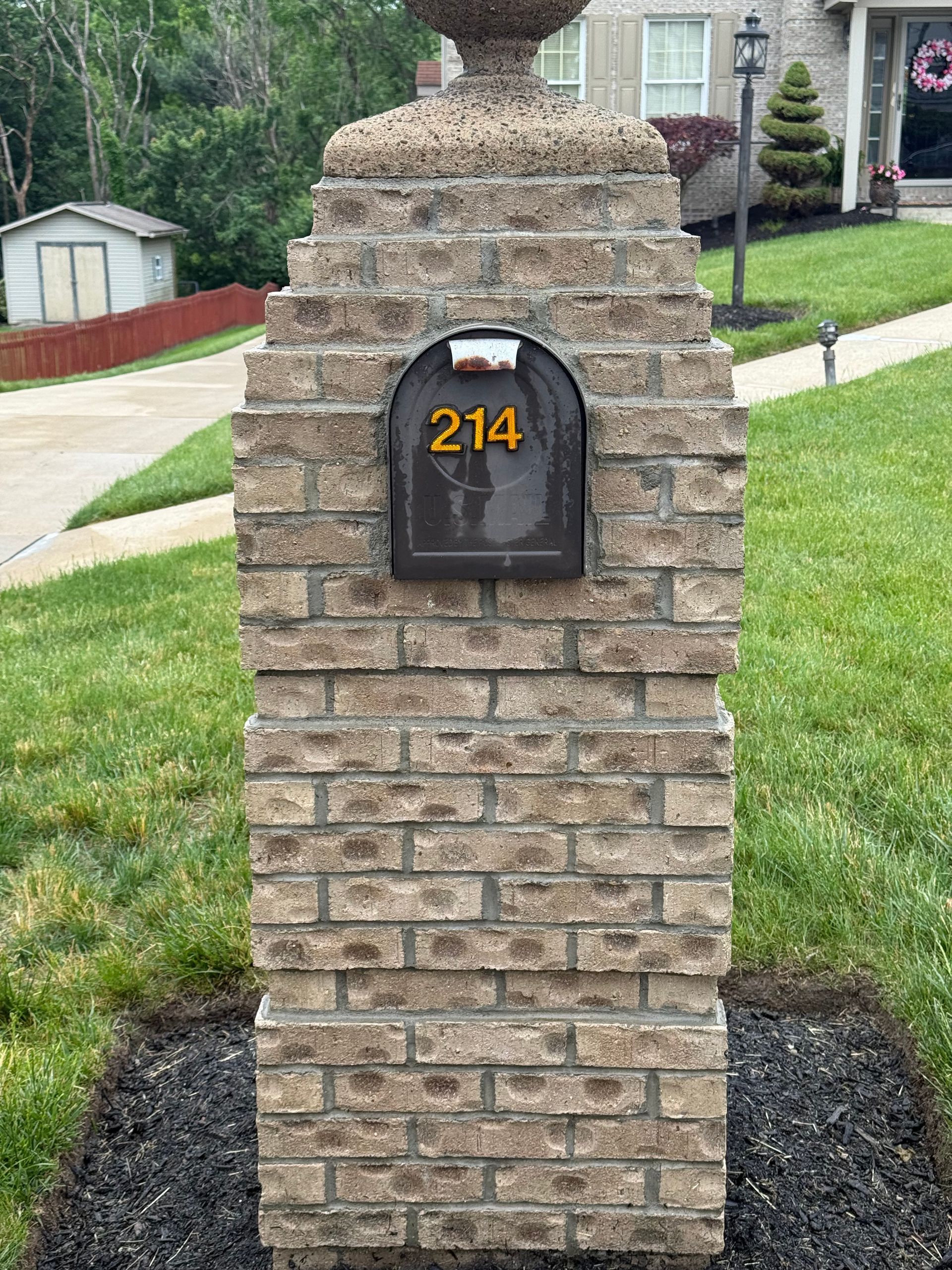 Brick mailbox pillar after pressure washing