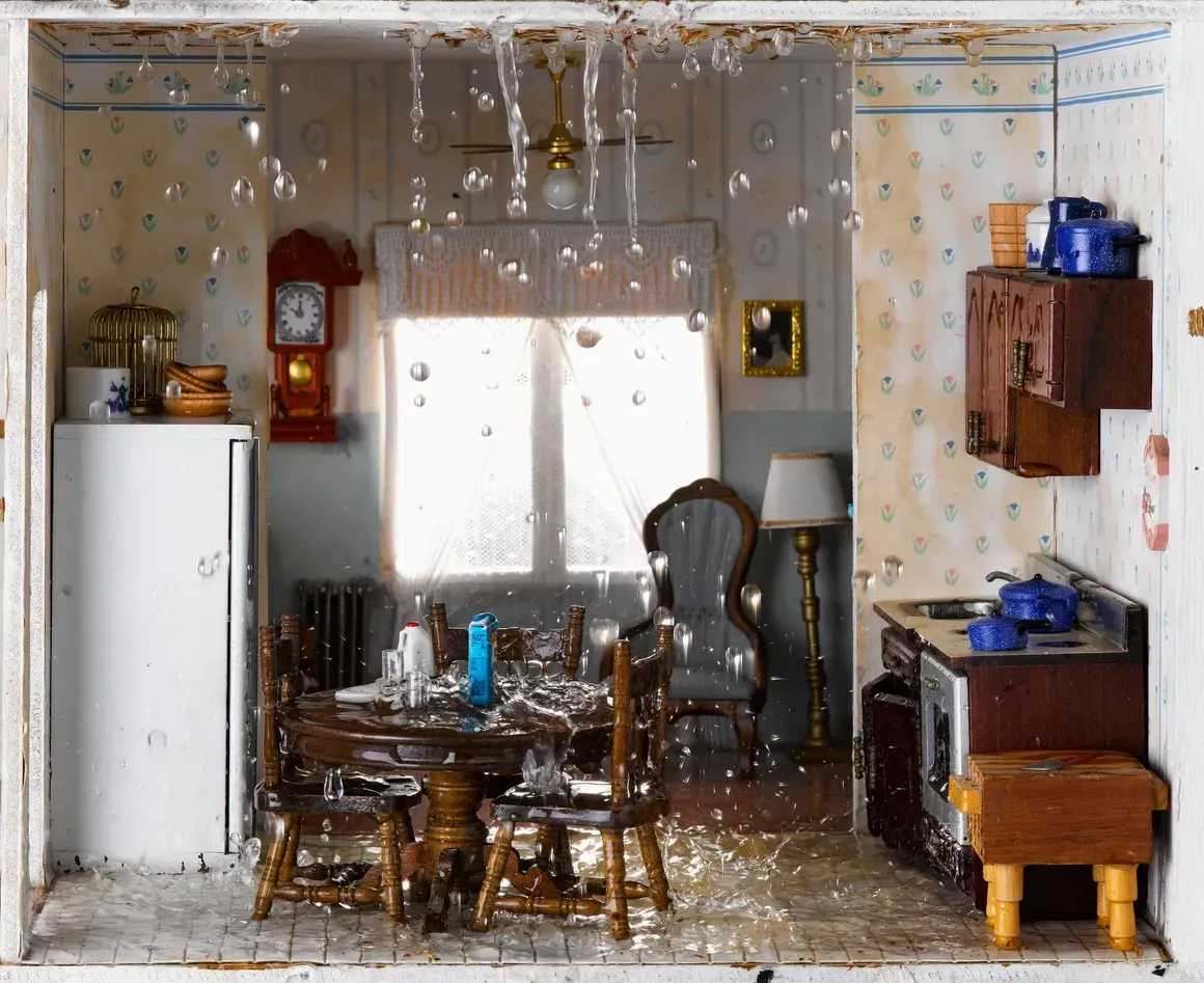Dollhouse dining room with a table, chairs, cabinets, and a window in the back wall.