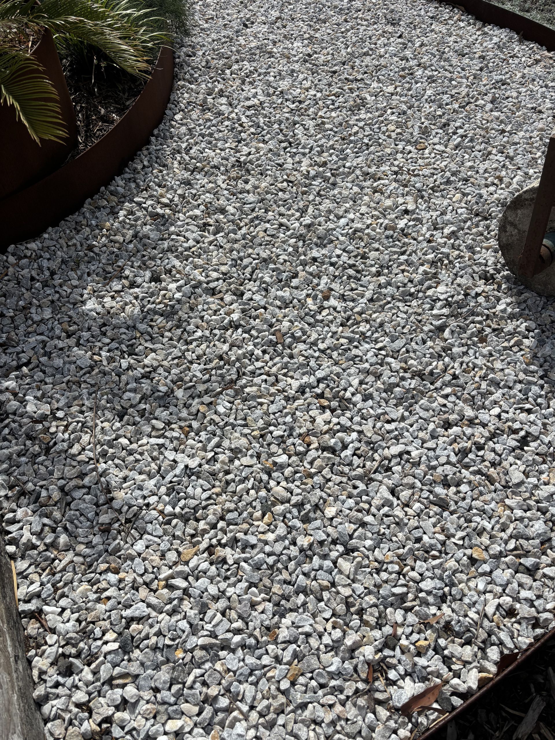Gravel pathway in a garden bed with a rusted metal border — Schutz Landscape and Garden Supplies in Tomerong, NSW